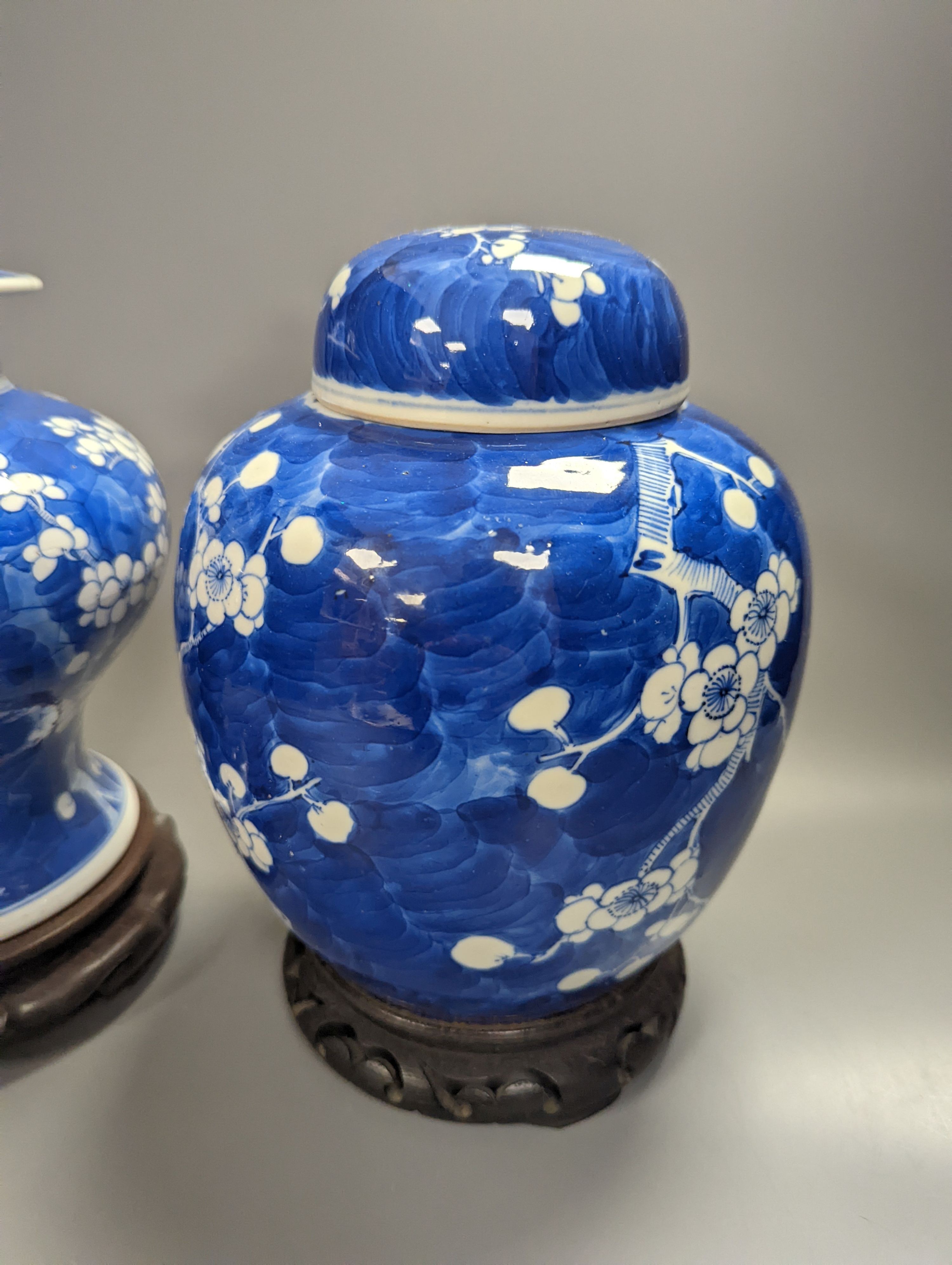 An 18th century Chinese blue and white prunus baluster jar and associated cover and a 19th century ginger jar, tallest 27cm incl. stand